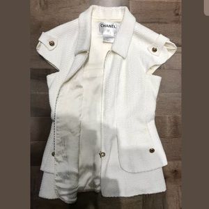White Chanel vest with gold accents.